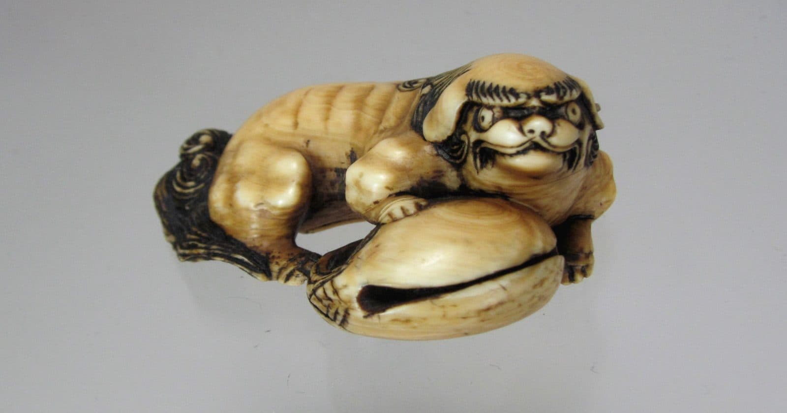 ASAKUSA School Netsuke of a Fu Lion and Mokugyo